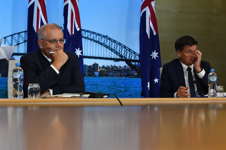 two men sit at desk