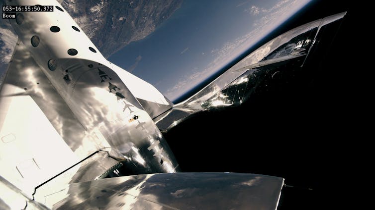 VSS Unity in space during a test flight, with its wings stowed away in preparation for feathered re-entry. This specific model has completed 21 successful test flights, with three reaching space.