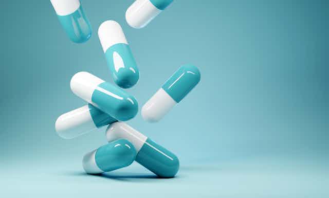 A bunch of blue and white antibiotics on a blue background.