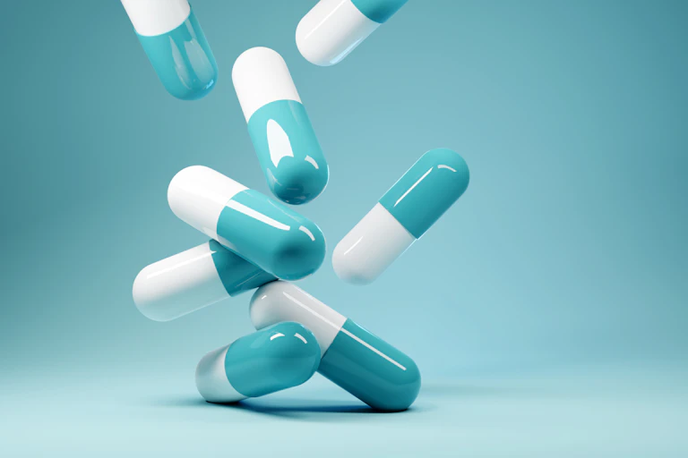 A bunch of blue and white antibiotics on a blue background.