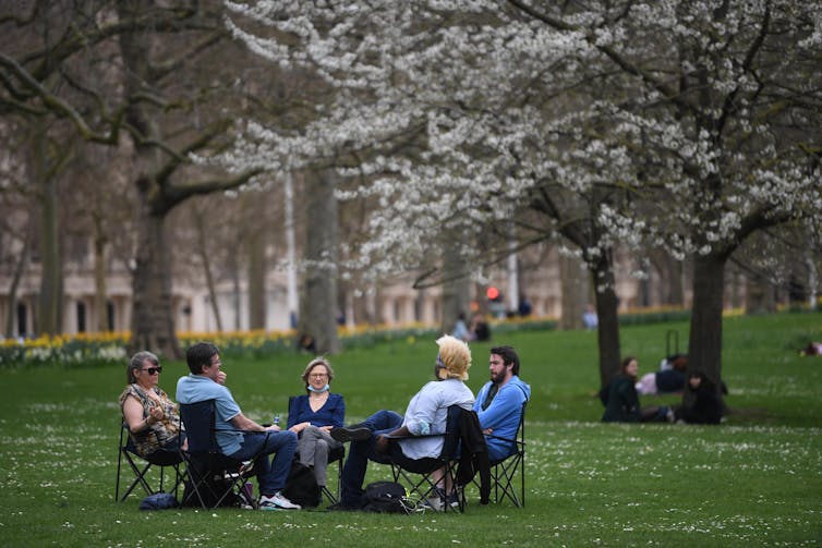 People socialising outside in a park