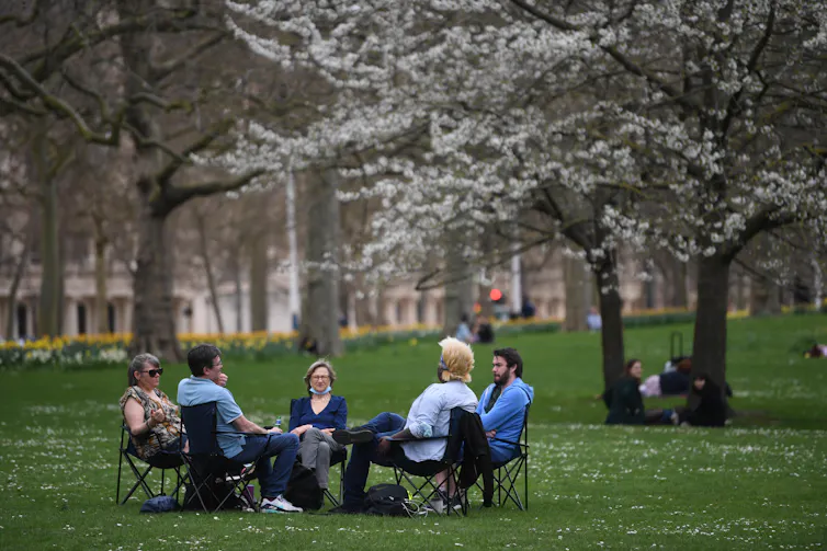 People socialising outside in a park