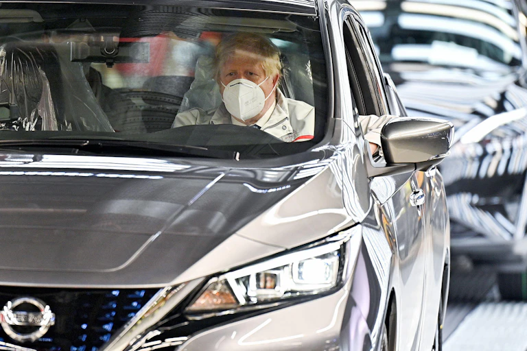 Boris Johnson in a new Nissan on the production line.
