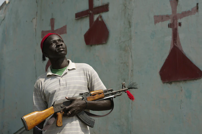 A South Sudanese civilian stands in front of a church in South Sudan