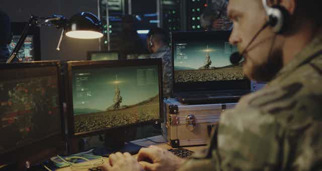 Soldier at computer controlling rocket launch.