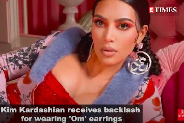 American reality TV star Kim Kardashian wearing earrings patterned from the sacred Hindu Om during a photoshoot.