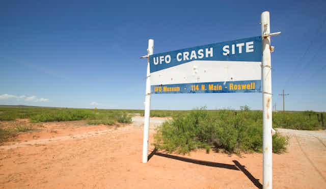 A sign in the desert saying 'UFO crash site.'