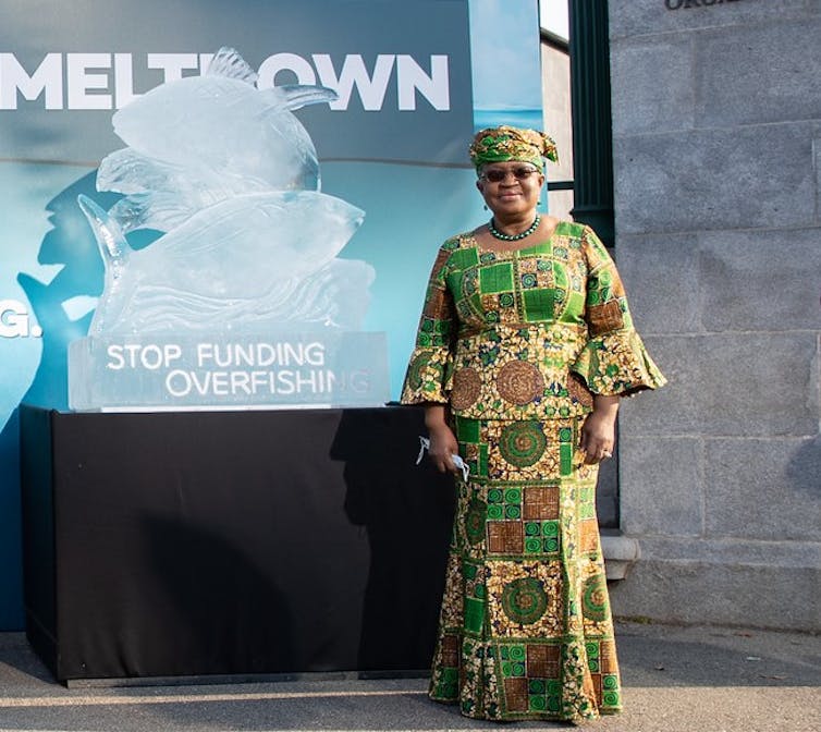Director General Ngozi Okonjo-Iweala with an ice sculpture of fish titled Stop Funding Overfishing