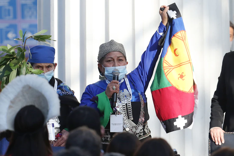 Indigenous Chilean academic Elisa Loncon, wearing a face mask and holding up a Chilean flag, makes a speech in Santiago, CHile, July 4 2021.
