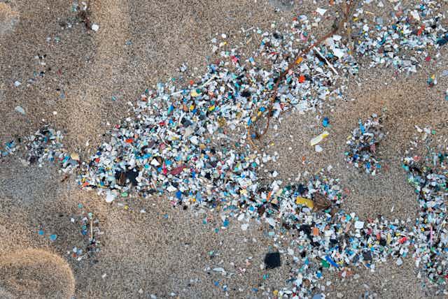 hundreds of small plastic bits in the sand