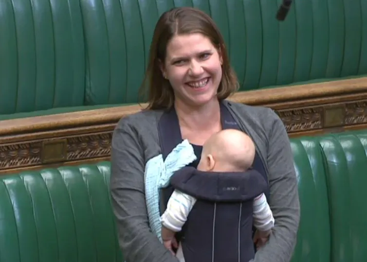 MP Jo Swinson in the House of Commons with an infant in a chest carrier