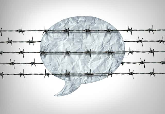 A speech bubble overlaid with barbed wire
