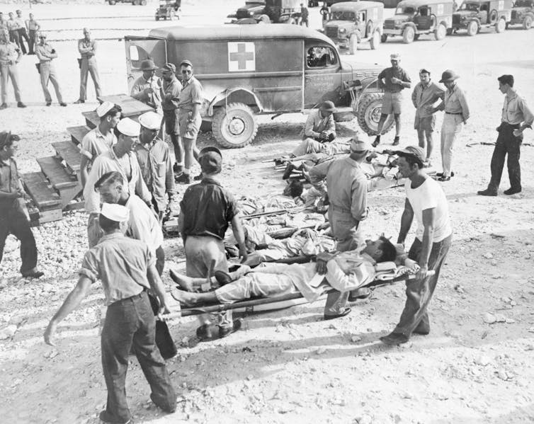 Survivors are carried on stretchers following their rescue.