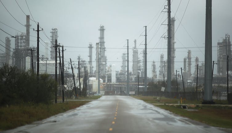 A refinery and wet road during a severe rain storm.