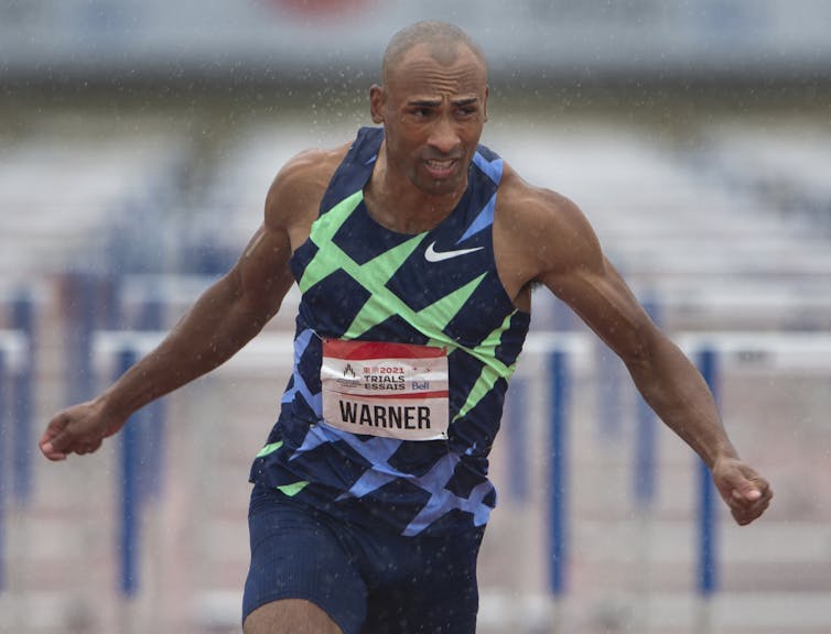 Man mid-run with his arms stretched out behind him.