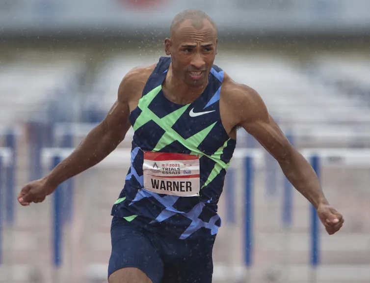 Man mid-run with his arms stretched out behind him.