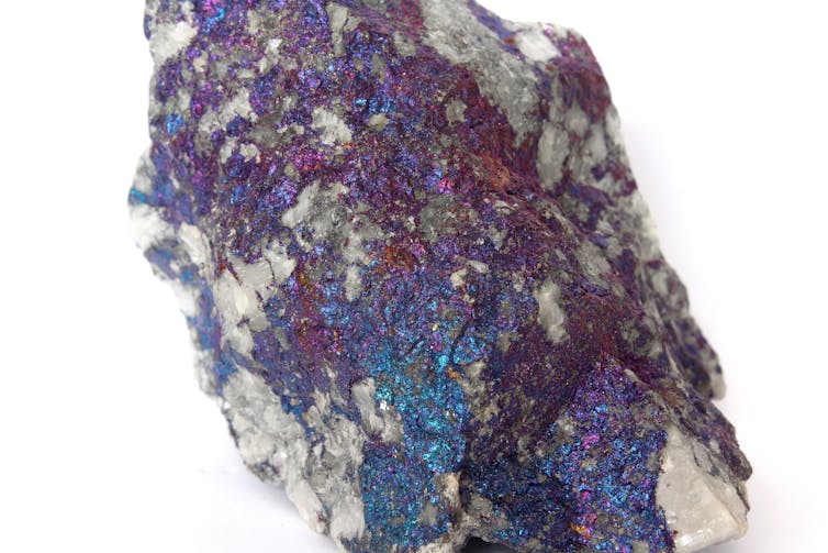 A sample of copper hosted in a quartz vein in the form of a mineral called chalcopyrite. When exposed to air, the surface oxidises to create this metallic ‘peacock’ lustre. Marek Novotňák / Wikimedia Commons