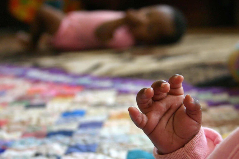 baby's hand with baby blurred in the background