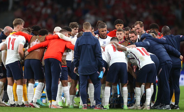 Gareth Southgate speaks to his squad on the pitch after 90 minutes on the pitch against Denmark.