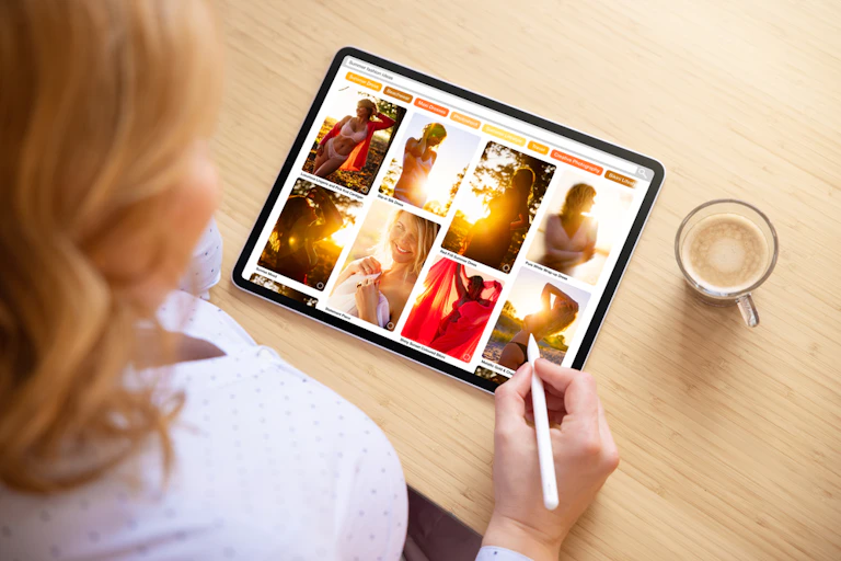 A woman looking through a pinterest board of beautiful images of women on an ipad