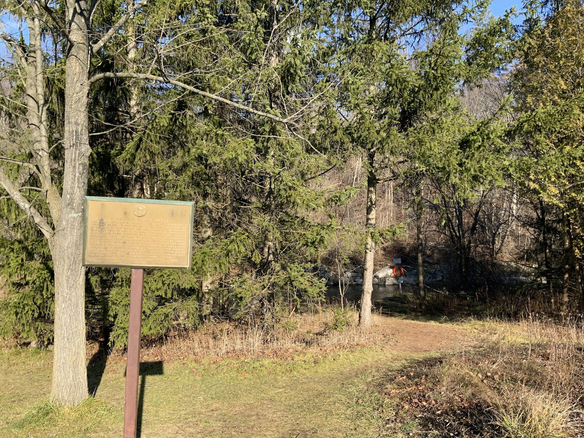 A plague is displayed next to a creek