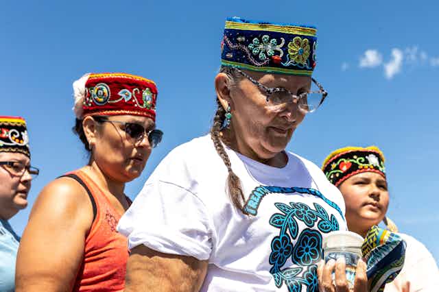 Indigenous women pray for water during an environmental protest