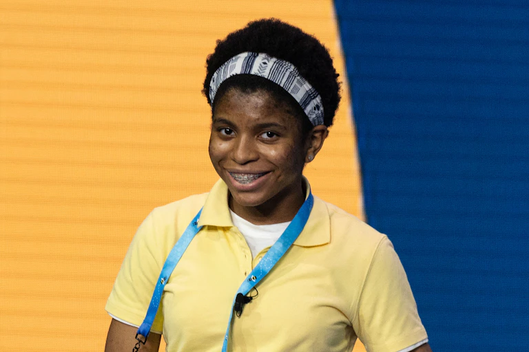 A photo of a young Black American girl smiling.