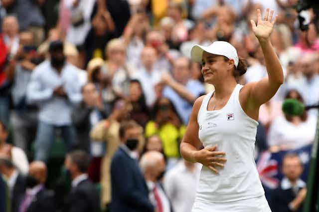 Ashleigh Barty waves to the Wimbledon crowd. 