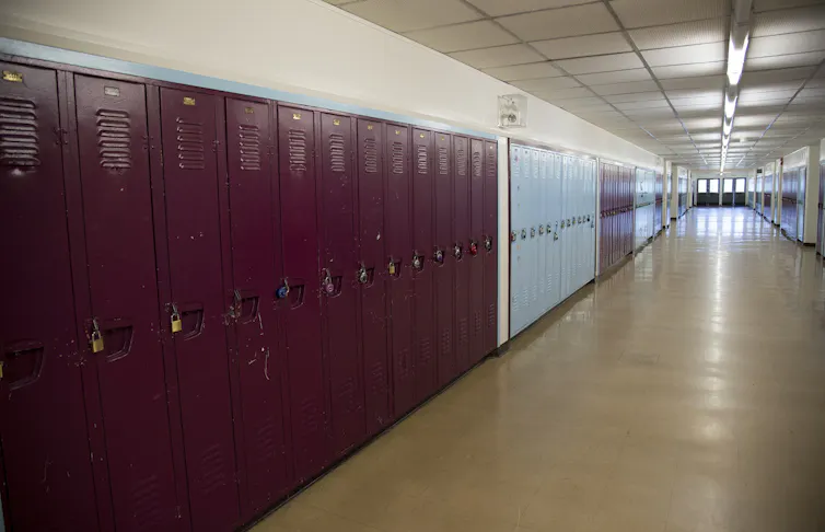 Long rows of lockers in an empty school hallway