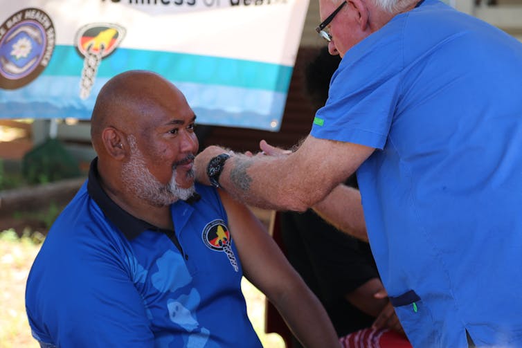 Aboriginal elder receives a coronavirus vaccine.