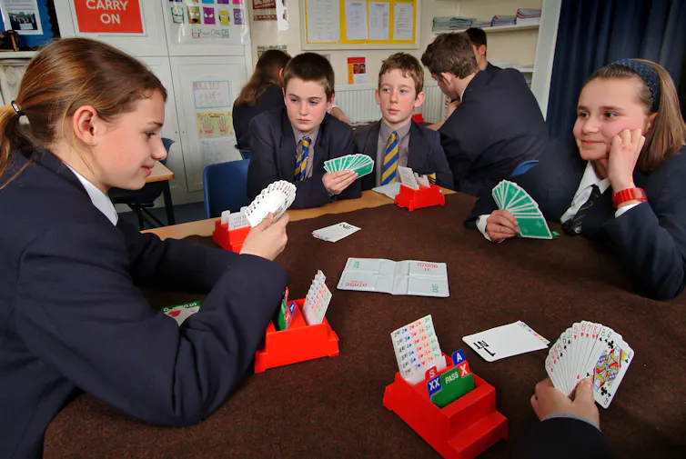 Secondary school pupils play cards in a maths lesson
