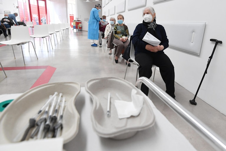 Elderly people lined up for their COVID vaccine.