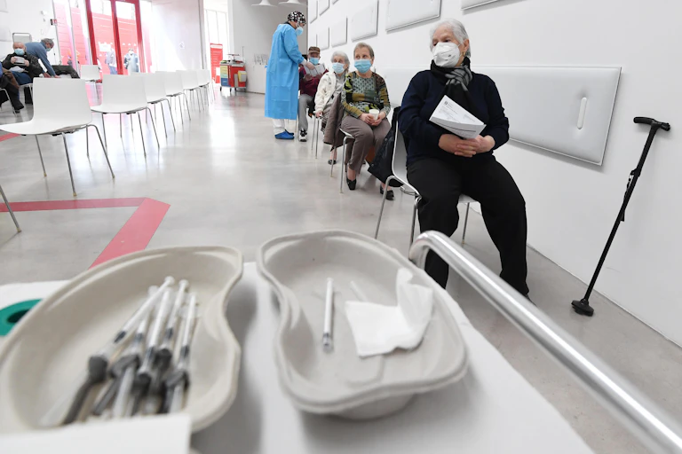 Elderly people lined up for their COVID vaccine.