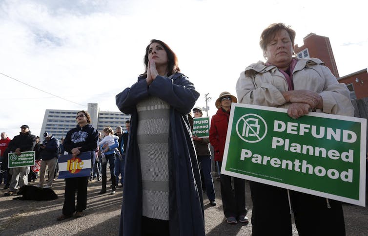 Abortion protesters listen to clergy deliver speeches and pray