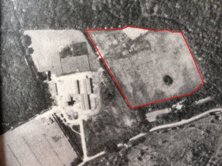 A black-and-white aerial photograph of the field station with an empty farm field highlighted.