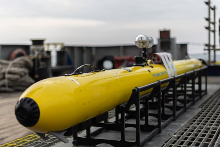 An Autonomous Underwater Vehicle (AUV) on deck.