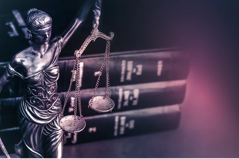 statue of blind justice and law books