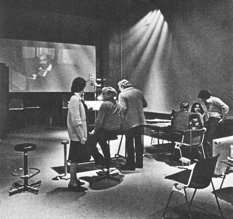 People in a studio recording Italian voiceovers for an English film.