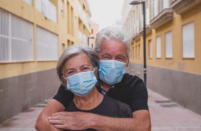 Elderly couple wearing face masks