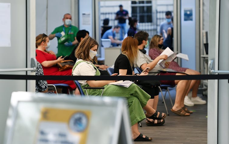 Young people waiting at a COVID-19 vaccine centre