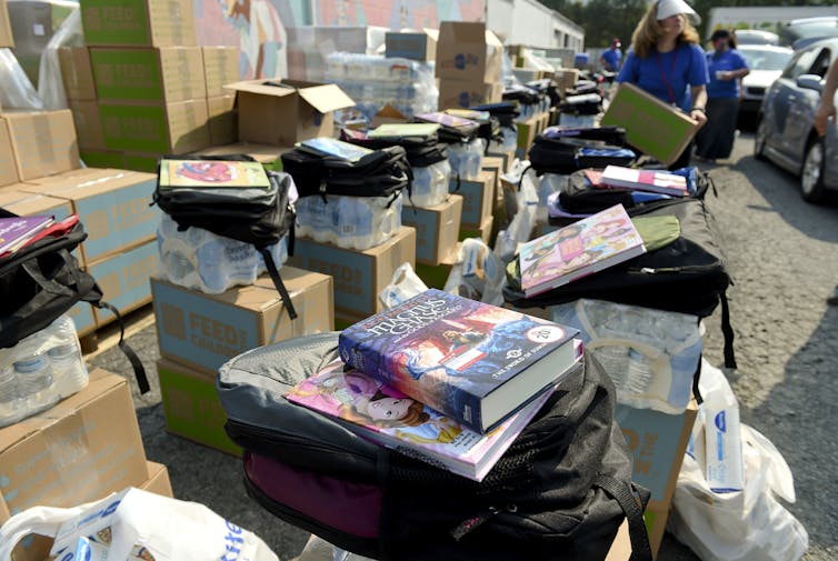 Colorful stacks of books, backpacks and other school supplies