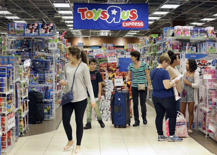 Shoppers in a Toys 'R' Us.