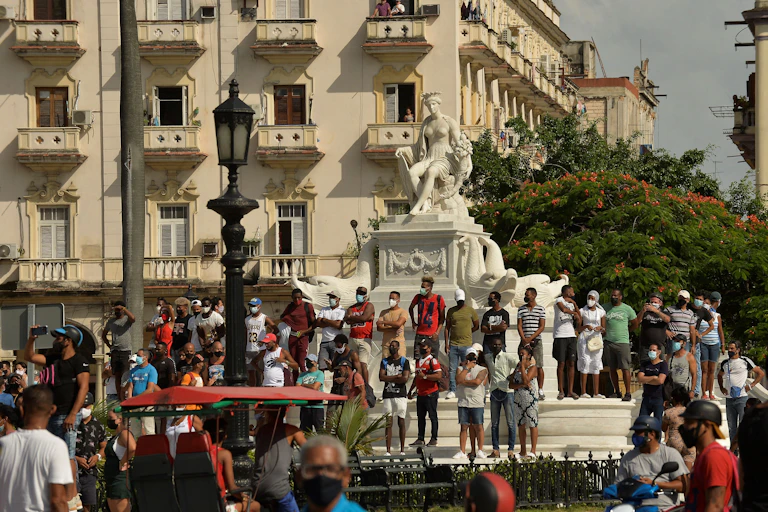 People stand at the base of a statue