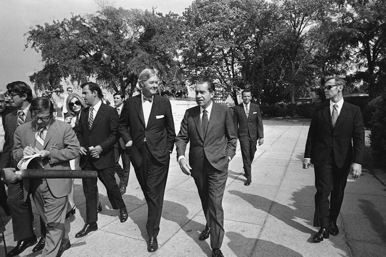 President Richard Nixon, center, accompanied by Daniel Patrick Moynihan