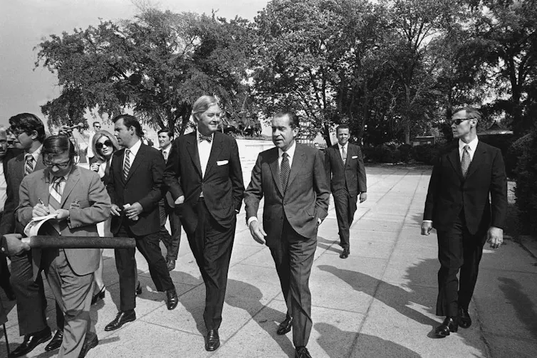 President Richard Nixon, center, accompanied by Daniel Patrick Moynihan