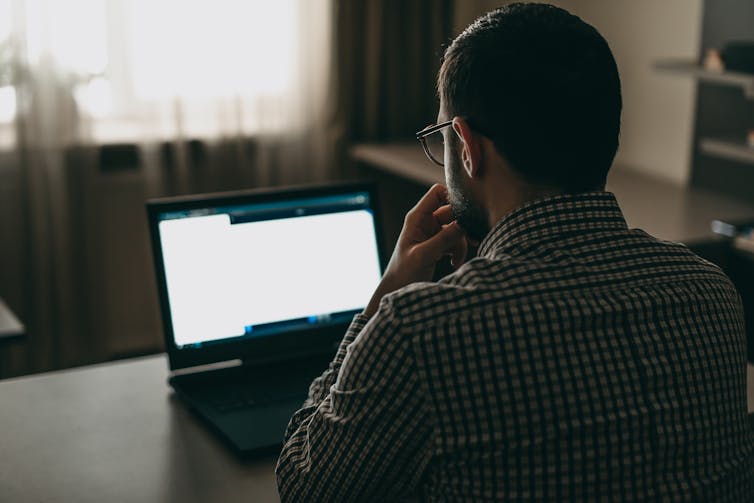 Man reads from laptop