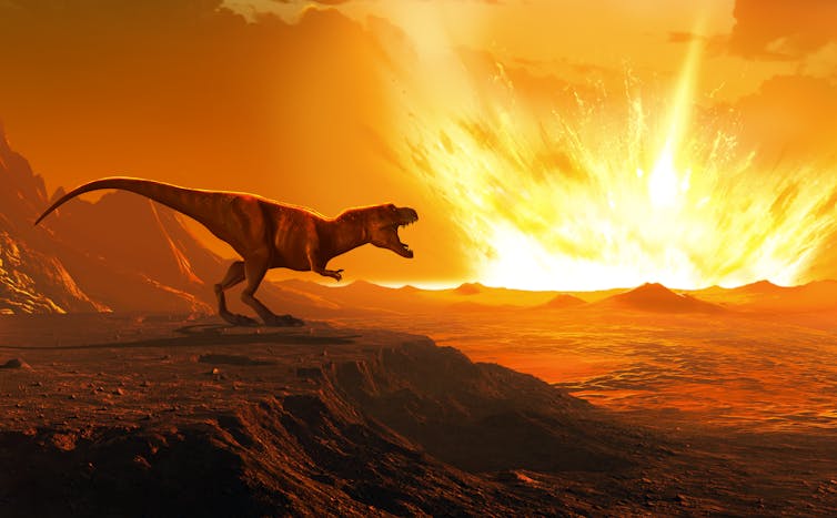 A dinosaur watches an asteroid strike the Earth.