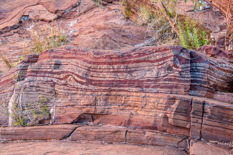 Red and brown bands along a rock face
