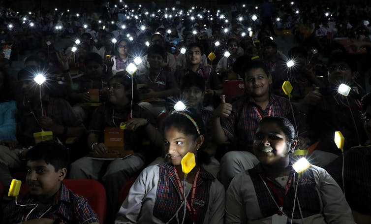 students hold lights