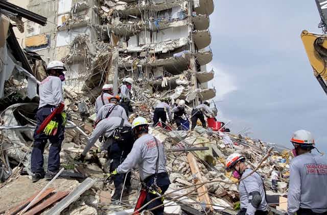 Rescuers search for survivors in a collapsed building